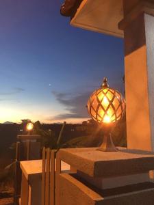a lamp sitting on the side of a building at Homestay Melaka Urich in Melaka