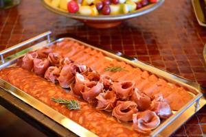 a tray of salmon with meat on top of it at Pousada Convento de Tavira in Tavira