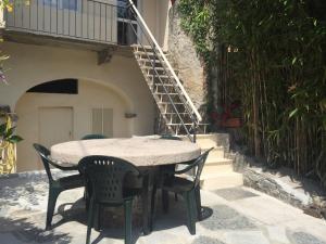 a table and chairs in front of a building at Appartamenti Edvina in Baveno