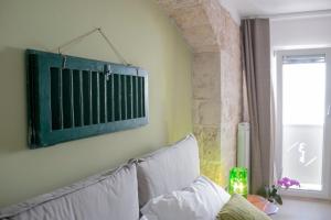 Postel nebo postele na pokoji v ubytování Dei Balzi Dimore di Charme