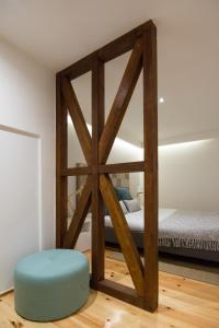 a room with two bunk beds and a blue ottoman at Casa Castelo 2- Work or Relax in the historic heart of Lisbon! in Lisbon