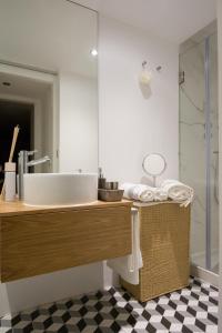 a bathroom with a large sink and a shower at Casa Castelo 2- Work or Relax in the historic heart of Lisbon! in Lisbon