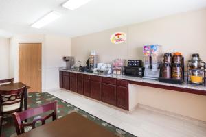 a hotel room with a counter with a coffee bar at Super 8 by Wyndham Jefferson in Jefferson