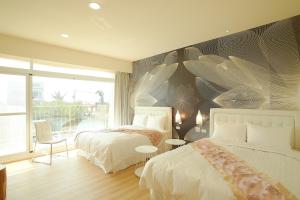 Postel nebo postele na pokoji v ubytování 大鵬灣瞭望台 Top Bay B&B