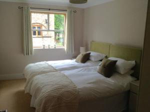 a bedroom with a large white bed with a window at 12 Emperors Wharf in York