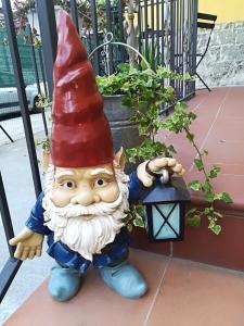 a statue of a gnome standing next to a lantern at Locanda del Golfo in La Spezia