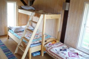 a bunk bed in a room with a bed and a bunk bedutenewayeway at Aasavälja Rannamaja in Kabli