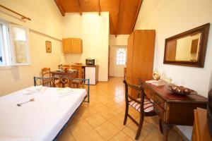 a living room with a table and a kitchen at Boulevard Panorama Suites in Agia Effimia