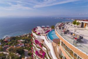 a beach scene with a balcony overlooking the ocean at Grand Miramar All Luxury Suites & Residences in Puerto Vallarta