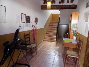 a room with a table and a black horse on a chair at Apartamentos Casa Ferrás in Valderrobres