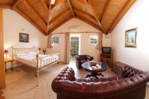 a living room with a couch and a table at Boulevard Panorama Suites in Agia Effimia