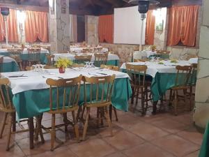 a group of tables and chairs in a banquet hall at Grappolo B&B affittacamere in Ascea +48 photos