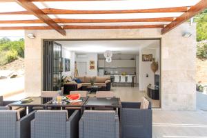 a living room with a table and chairs at Villa Tajna in Tivat