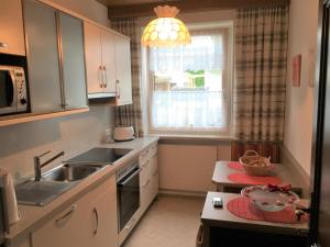 a small kitchen with a sink and a window at Appartements Michaela in Westendorf