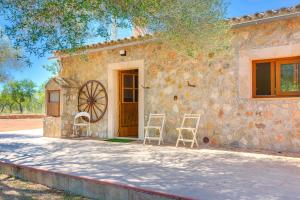 a stone house with two chairs outside of it at Villa Calvià countryside in Calvià