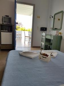 a bedroom with a bed and a door to a balcony at Amaranto Rooms in Aegiali +31 photos