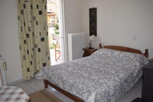 a bedroom with a bed and a door to a patio at Miloi Rooms and Apartments in Míloi