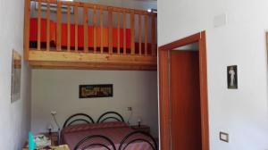 a bedroom with a bunk bed and a staircase at Il Girasole Alloggio in Fluminimaggiore +13 photos