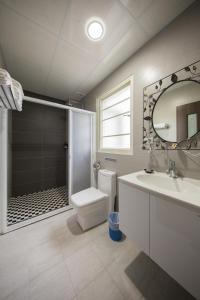 a bathroom with a shower and a toilet and a sink at Joanne B&B in Taitung City