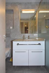 une salle de bains avec un lavabo blanc et un miroir dans l'établissement Pushkin 49, à Erevan 13 autres photos