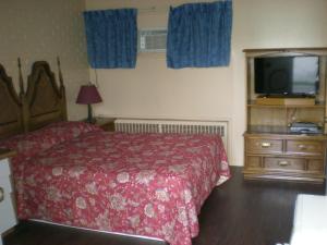 Cama o camas de una habitación en Motel Seigneurie de Vaudreuil
