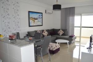 a living room with a couch and a table at Marina Golf Asilah in Asilah