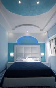 a bedroom with a large bed with a blue ceiling at Golfo Delle Sirene in Sorrento