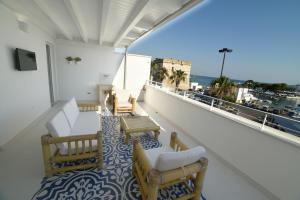 a balcony with chairs and a view of the ocean at Latino Rent Room B&B vista mare in Porto Cesareo