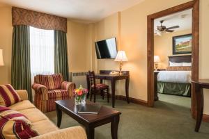 a hotel room with a couch and a table and a bed at Missouri Athletic Club in Saint Louis