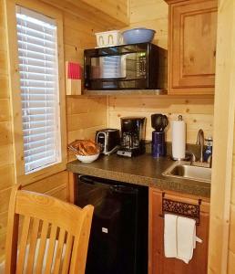 a small kitchen with a sink and a microwave at Colorado River RV Campground in Columbus