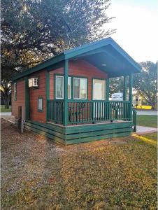 a small cabin with a porch in a park at Colorado River RV Campground in Columbus