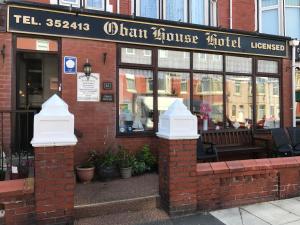 a brick building with a sign for a restaurant at Oban House in Blackpool