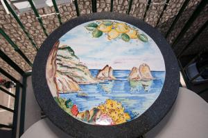 a plate with a painting of the ocean at Golfo Delle Sirene in Sorrento
