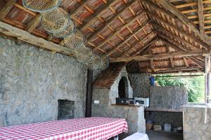 a room with a table and a fireplace in a house at Chalet Ljubicine kolibe in Golubinje
