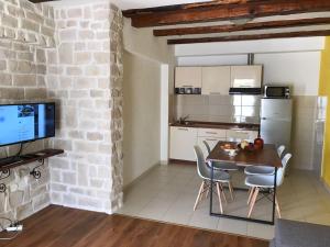 a kitchen and dining room with a table and chairs at Apartment Bruno in Šibenik