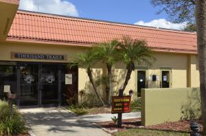 a building with a sign in front of it at Orlando RV Resort in Orlando