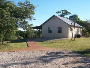 a brick house with a path leading to it at Breezy Hills Cottages - Moonlight Cottage in Fredericksburg