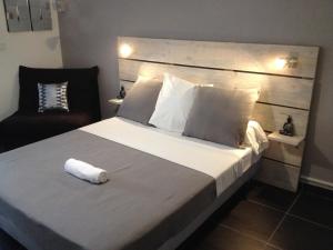 a bedroom with a bed with a towel on it at Studio Bas du Fort Guadeloupe in Le Gosier +6 photos