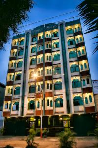 a tall building with windows and lights at Amara Hotel in Lima