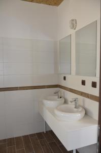 a bathroom with two sinks and a mirror at Hostel Antique in Pula