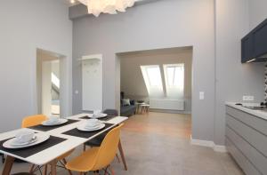 a kitchen and dining room with a table and chairs at Apartamenty Rewa in Rewa