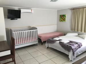 Tempat tidur dalam kamar di Hotel Pousada Mato Grosso