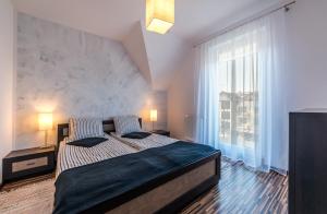 Un pat sau paturi într-o cameră la Apartament Soffitta