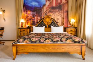 a bedroom with a large bed with a painting on the wall at Boutique Hotel Baku in Baku