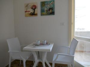ガリポリにあるB&B Ariostoの白いテーブルと椅子、白いテーブル、窓