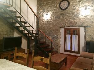 a living room with a staircase and a clock on the wall at Casa Marcial in Chía