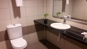 a bathroom with a toilet and a sink at Salsa Resort Langkawi By Casa Loma in Pantai Cenang