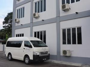 a white van parked in front of a building at Salsa Resort Langkawi By Casa Loma in Pantai Cenang