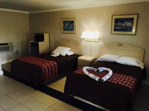 a hotel room with two beds in a room at Apollo Inn - Cocoa in Cocoa