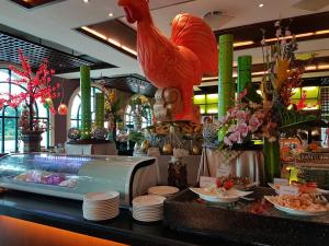 a restaurant with a large chicken on the counter at Waterfront Airport Hotel and Casino in Mactan